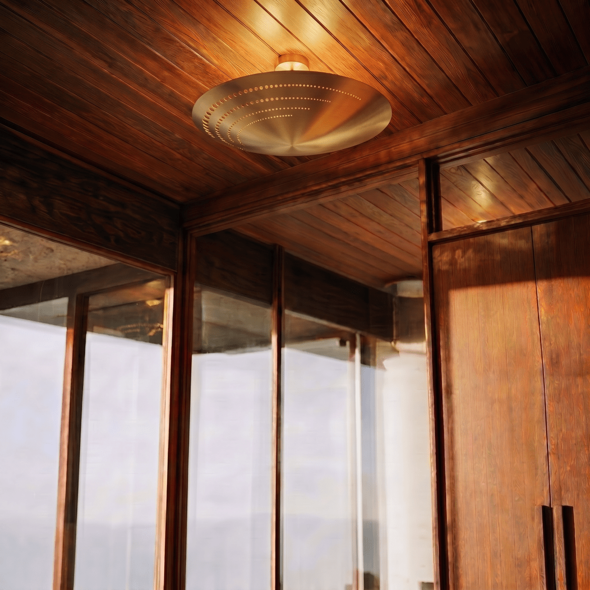 Clérachic ceiling light glowing in a sunlit wood-paneled hallway lined with glass and timber doors.