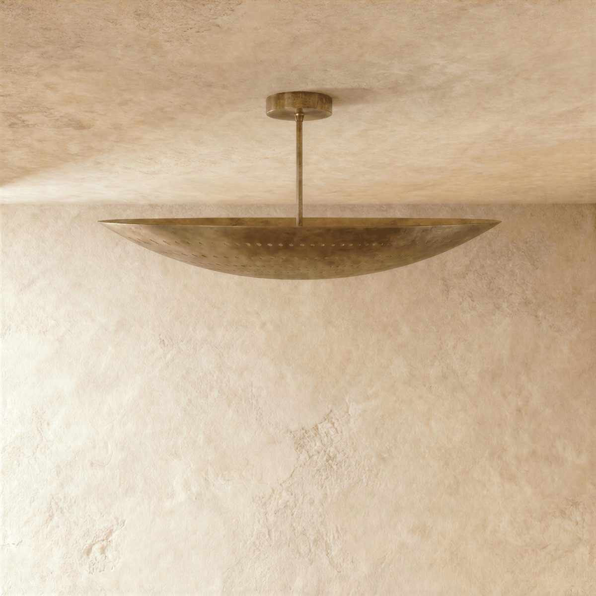 Clérachic ceiling light in vintage brass, close view of the curved perforated shade and slim rod.