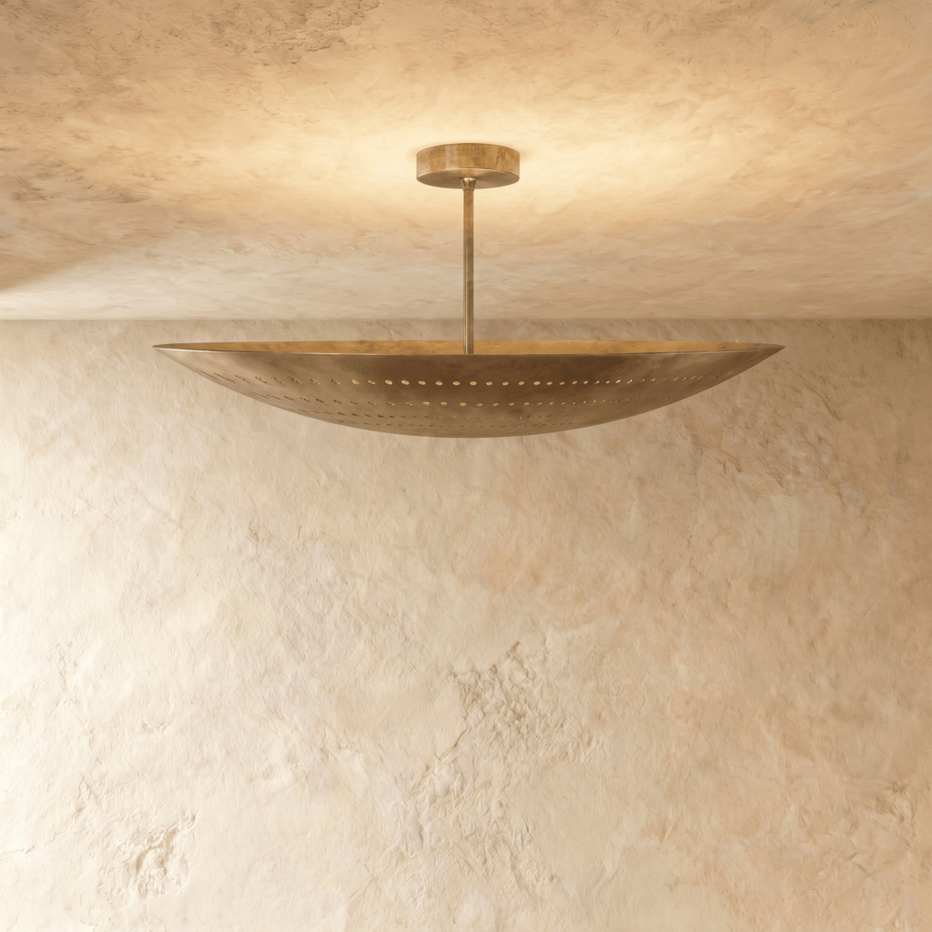 Clérachic ceiling light in vintage brass, a curved boat-shaped shade with pierced dot perforations.