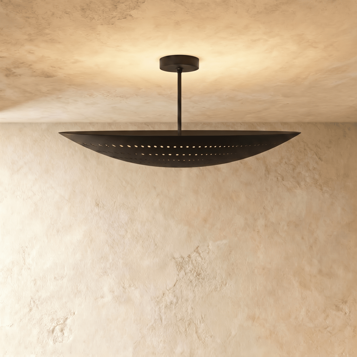 Clérachic ceiling light in matte black, a curved boat-shaped shade with pierced dot perforations.
