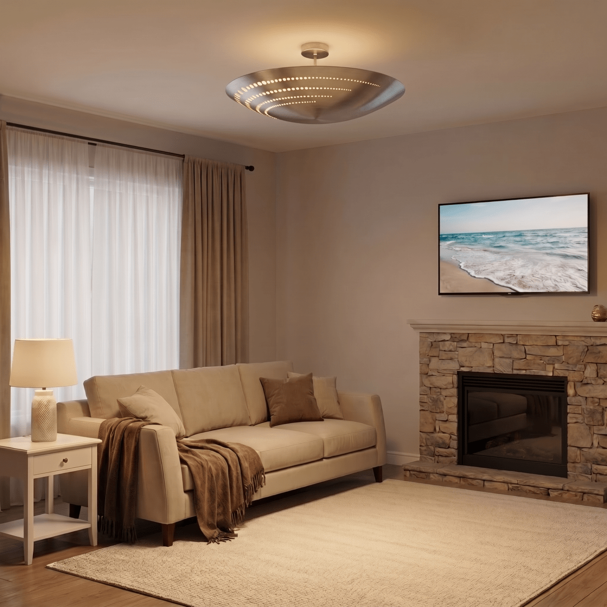 Clérachic ceiling light in chrome glowing above a living room with a stone fireplace and beach art.