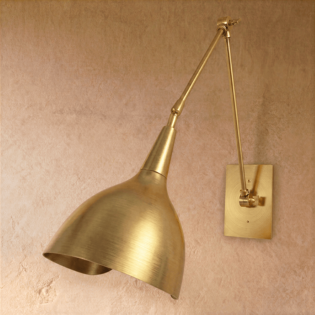 Clérachic wall lamp in polished brass, viewed from a slightly different angle with its cone shade lowered.