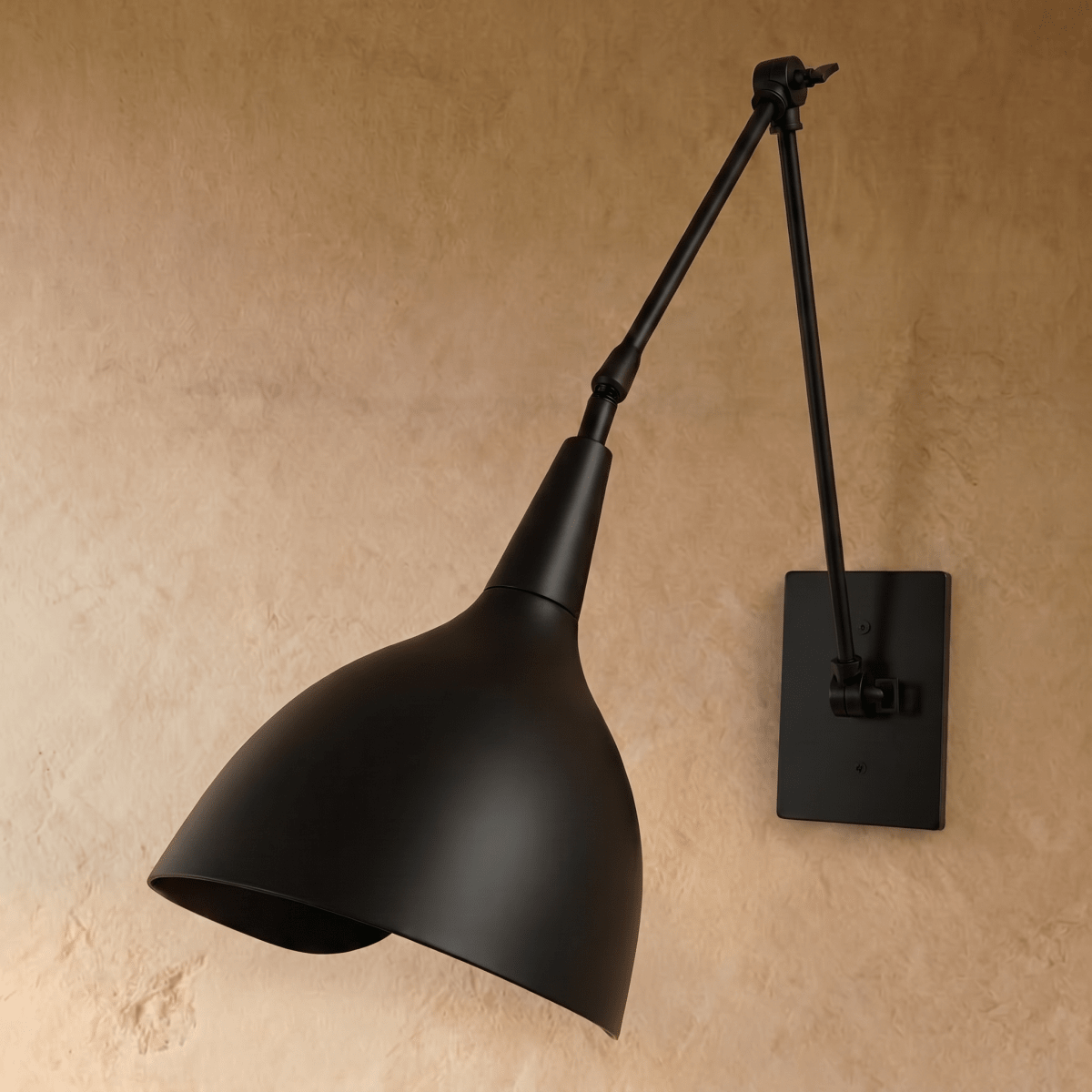 This black Clérachic wall lamp is shown from another angle, its swing arm and cone shade both matte black.