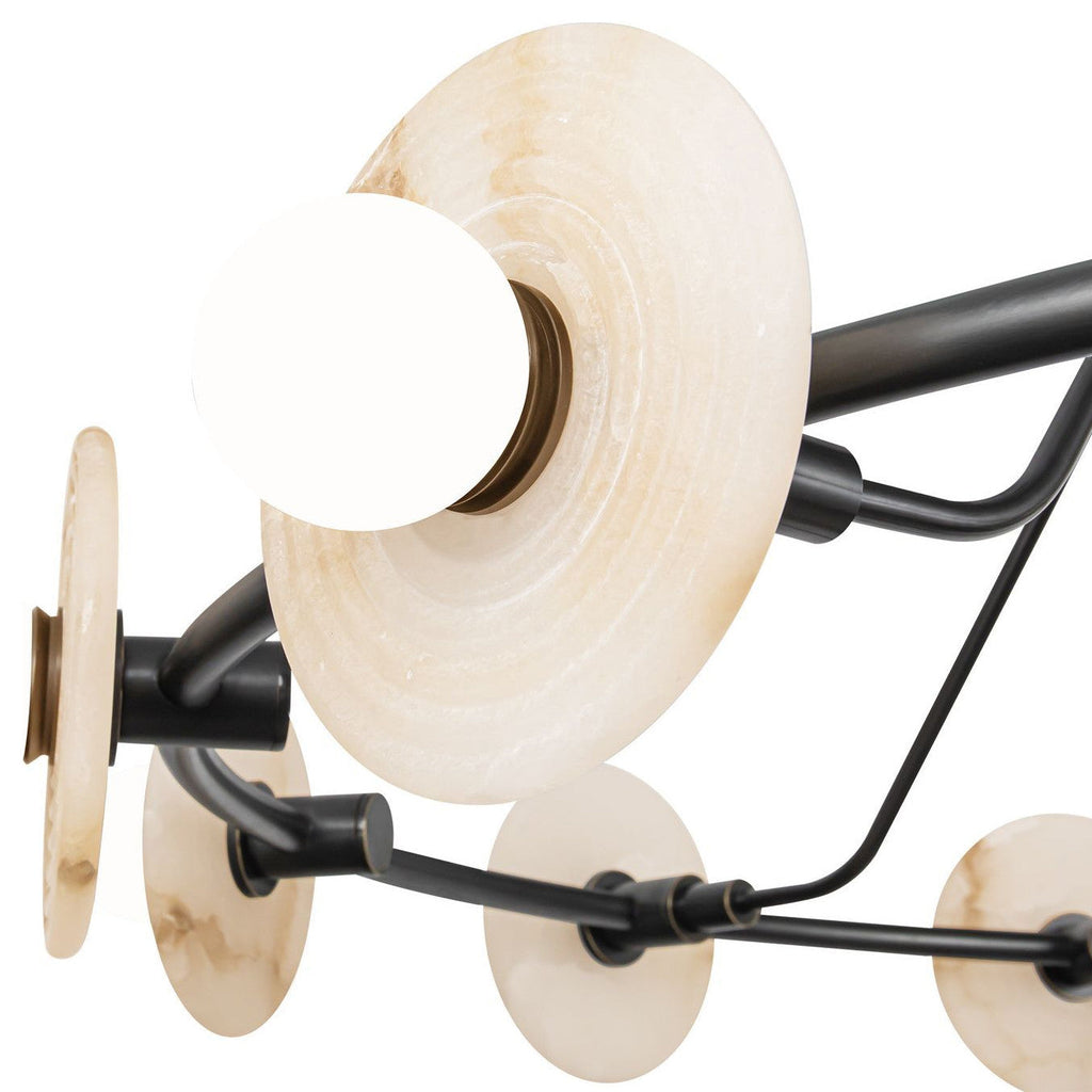 Close detail of one Clérachic chandelier head, a ribbed alabaster disc with its brass socket ring and opal globe bulb.