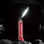 The Clérachic work light standing on rubble in a dark workshop, panel angled upward.