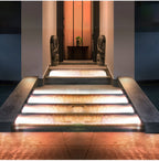 The Clérachic step lights lighting a run of pale entrance steps in front of a doorway.