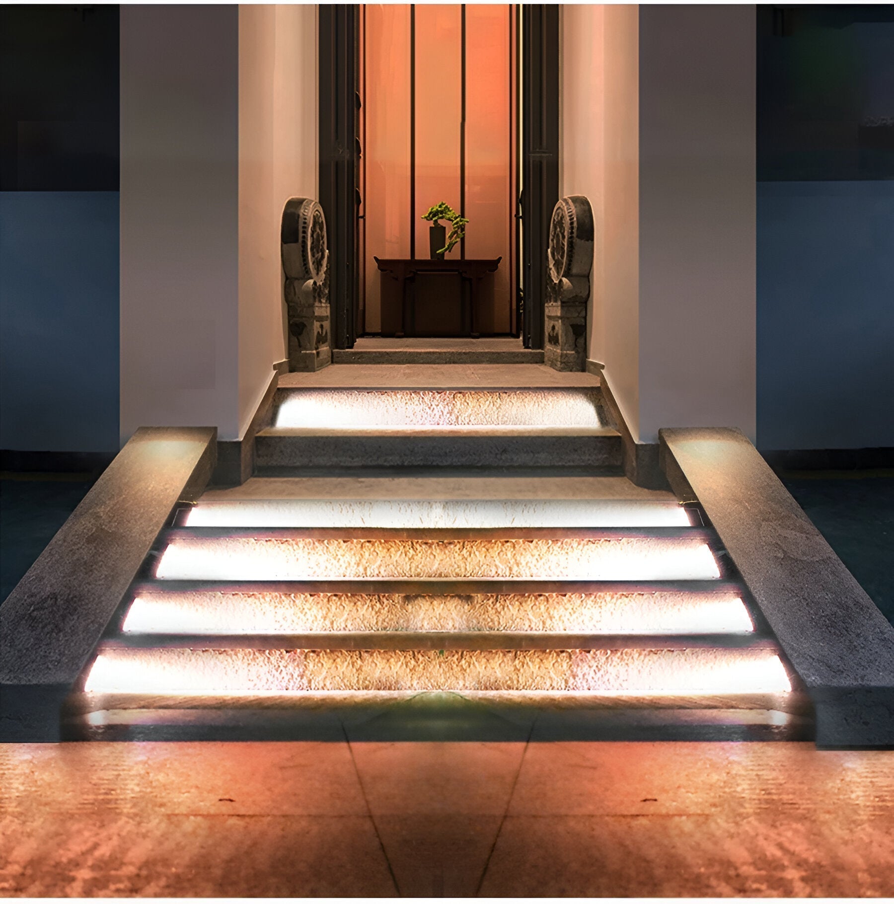The Clérachic step lights lighting a run of pale entrance steps in front of a doorway.