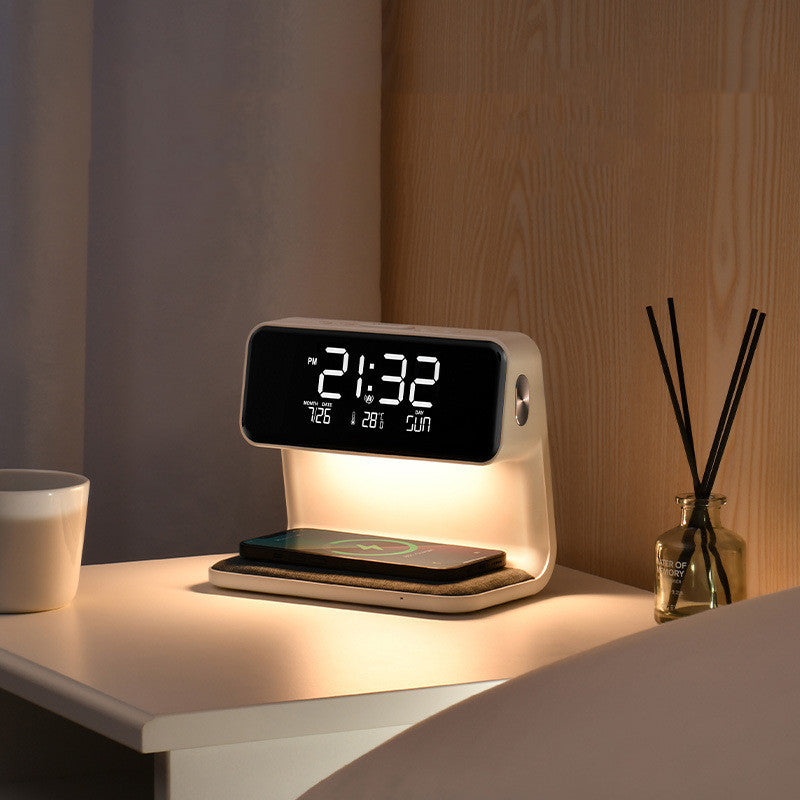 Clérachic bedside station lit warm, its LED clock above a wireless charging pad on a nightstand.