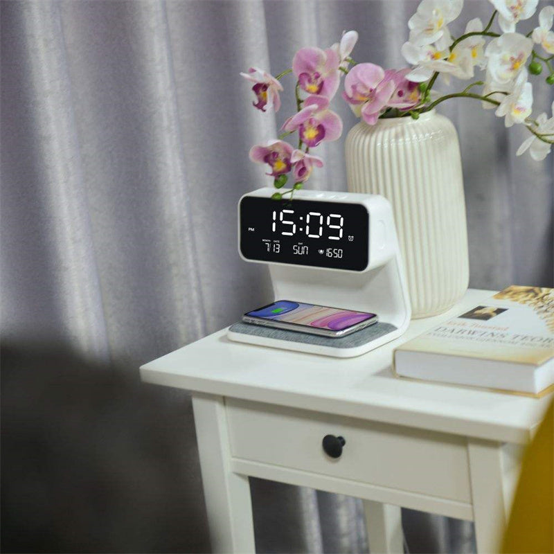 The Clérachic bedside station lit beside orchids and books on a white bedside table.
