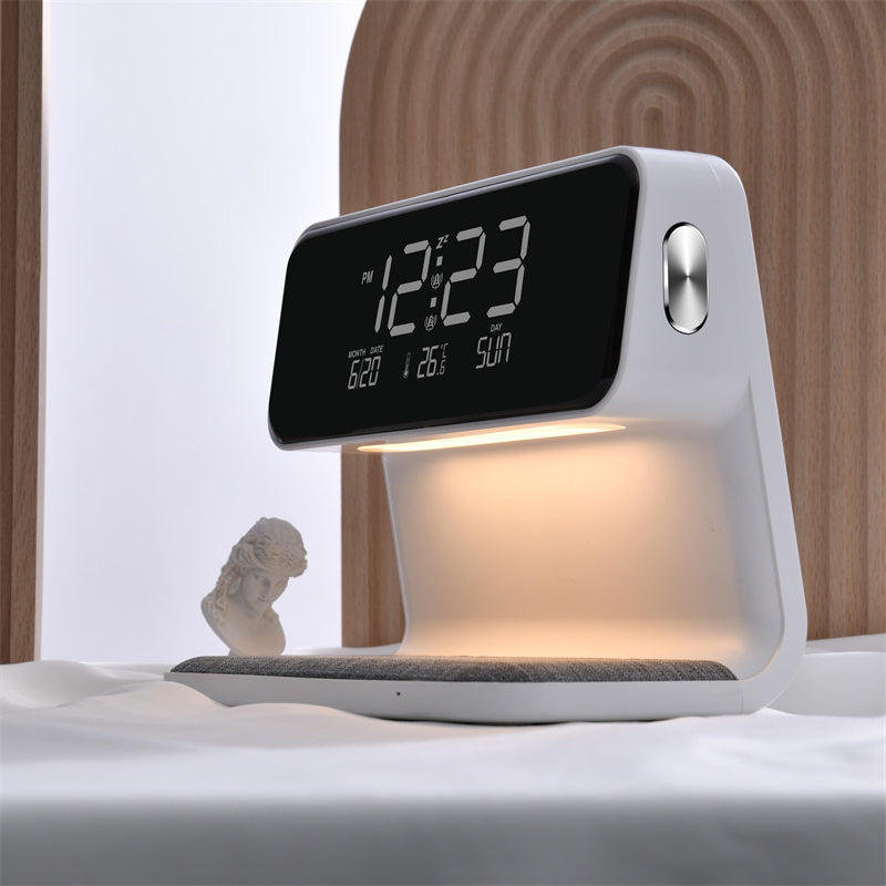 Clérachic bedside station on a pale surface, its warm underlight washing the charging pad.