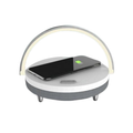 Clérachic 3-in-1 desk lamp in white, its arched LED bar above a wireless charging pad and speaker.
