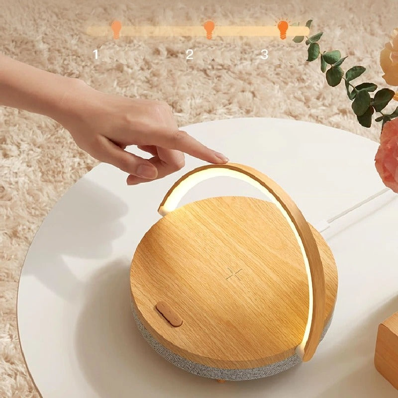 A hand touching the Clérachic lamp's wooden top to step through its three brightness levels.