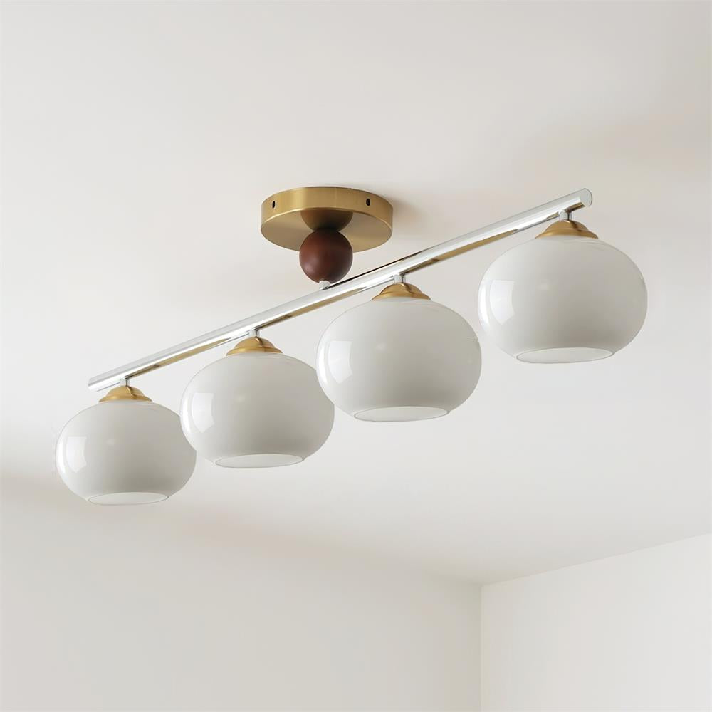 Clérachic 4-Dome Glass Bar Ceiling Light in clean white opal glass, unlit above a room corner, with brushed-brass cups at each shade.