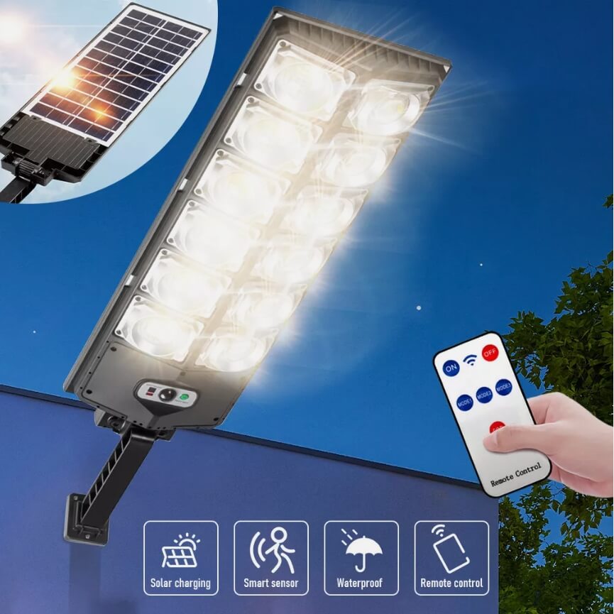 The Clérachic solar street light lit brightly, its tilting solar panel and remote alongside.