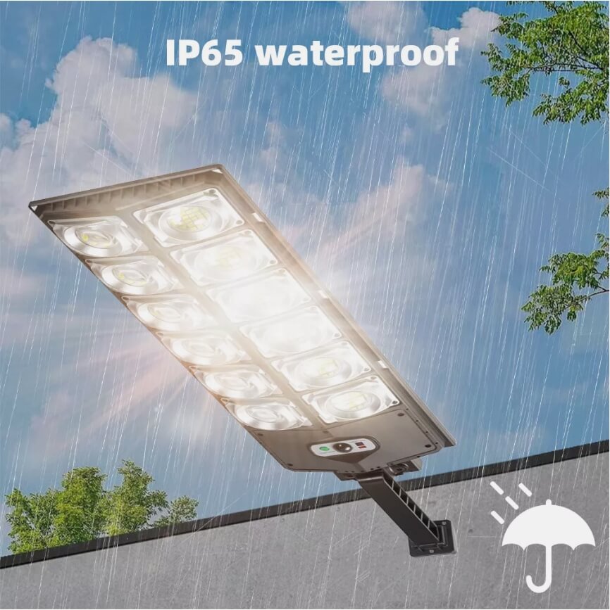 The Clérachic solar street light in heavy rain, marked with its IP65 weatherproof rating.