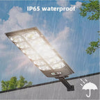 The Clérachic solar street light in heavy rain, marked with its IP65 weatherproof rating.
