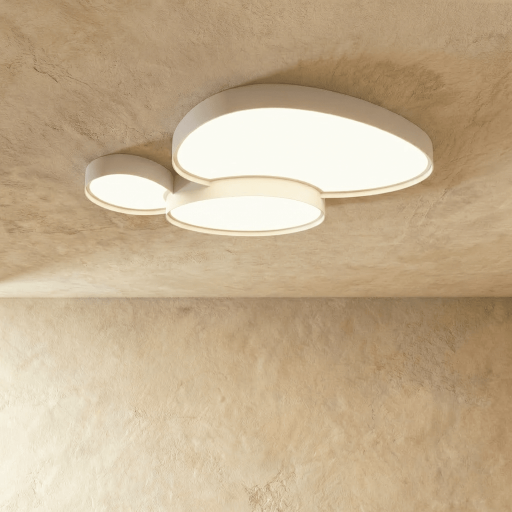 The Clérachic black overlapping-disc ceiling light installed above a walnut and green-tiled bathroom, glowing warm white.