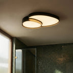 The Clérachic white overlapping-disc ceiling light installed in a sage green children's bedroom, glowing softly overhead.