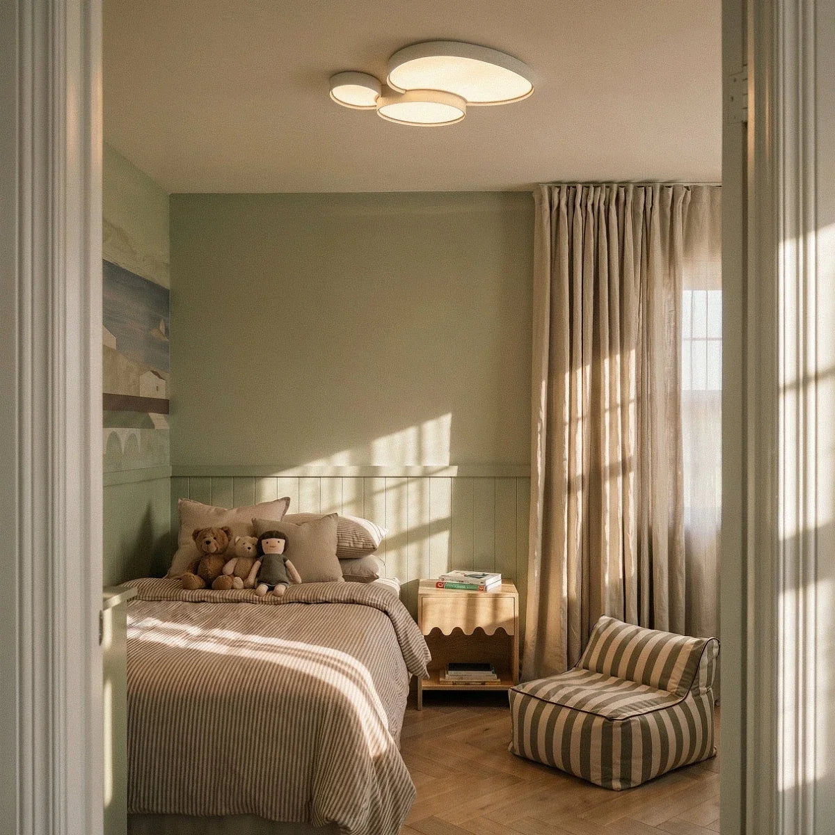 The Clérachic white ceiling light mounted above a sunlit bedroom with striped bedding and a bouclé floor cushion.