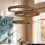 Clérachic three-tier ring chandelier detail, close-up on the perforated black bands and brass tier connectors.