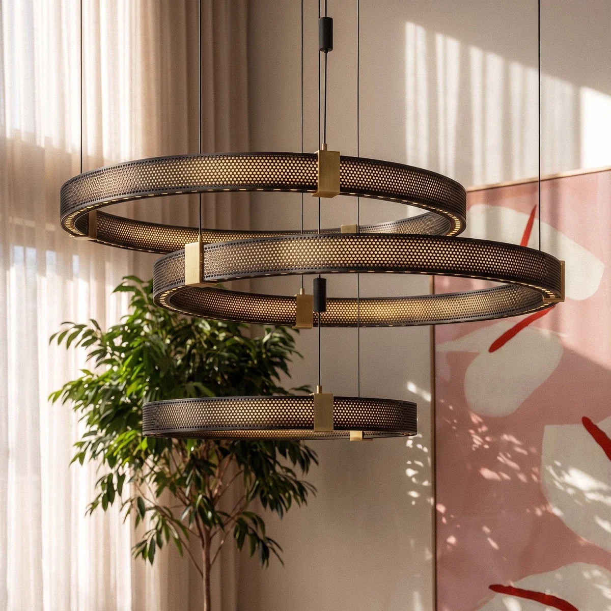 Clérachic three-tier ring chandelier detail beside a potted plant, perforated black bands lit warm from within.