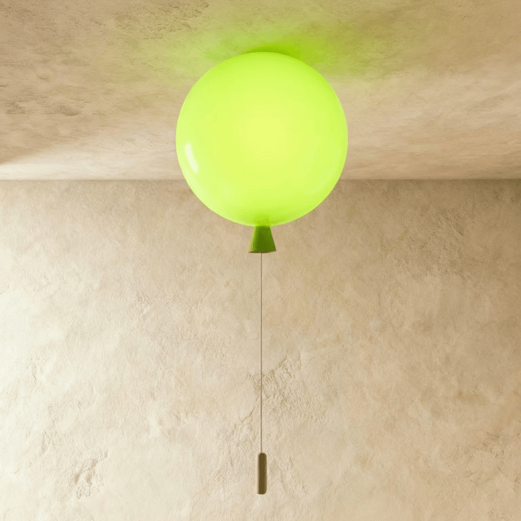 Clérachic balloon-shaped ceiling light in glossy lime green with a matching cone and pull cord, lit against a limewashed ceiling.