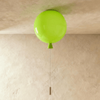 Clérachic round green ceiling light shaped like a balloon, switched off, with a green cone neck and a slim pull cord with a wooden toggle.