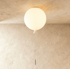 Clérachic frosted white balloon ceiling light with a white cone and cord, lit and fitted flush to a textured plaster ceiling.