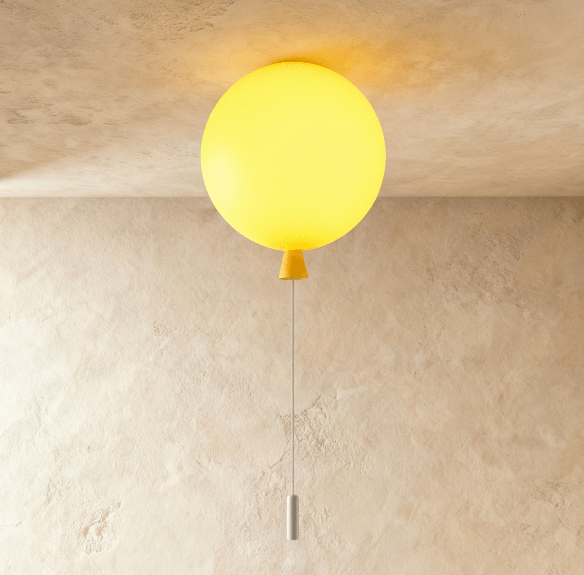 Clérachic round balloon ceiling light glowing sunny yellow, with a yellow cone neck and white pull cord, on limewashed plaster.