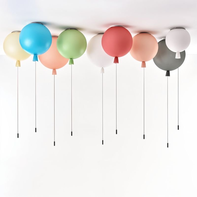 Clérachic balloon ceiling lights in a row on a white ceiling, in blue, peach, green, coral, white, grey and pale yellow with pull cords.