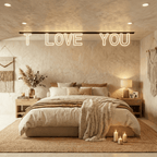 The Clérachic magnetic letter track light glowing warm white above a neutral bedroom headboard, spelling a message beside a table lamp.