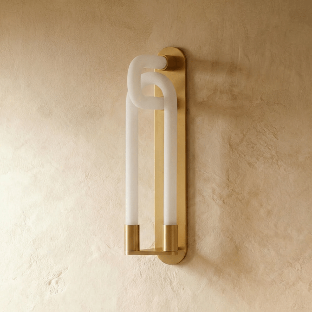 Clérachic wall light switched off, showing frosted white loops and brushed gold fittings on a textured plaster wall.