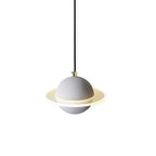 A Clérachic pendant with a grey sphere and a ridged light ring, on a clean white backdrop with a brass-tone cord top.