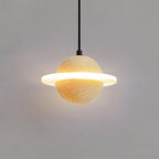 Sand yellow Clérachic pendant with a bright glowing ring and a warm halo behind it on a grey wall.