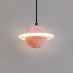 Coral-pink speckled Clérachic pendant with a glowing ring and a soft halo behind it, hanging on a black cord.