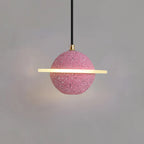 Sand pink Clérachic pendant with a flat glowing ring and brass cord top, hanging against a grey wall.