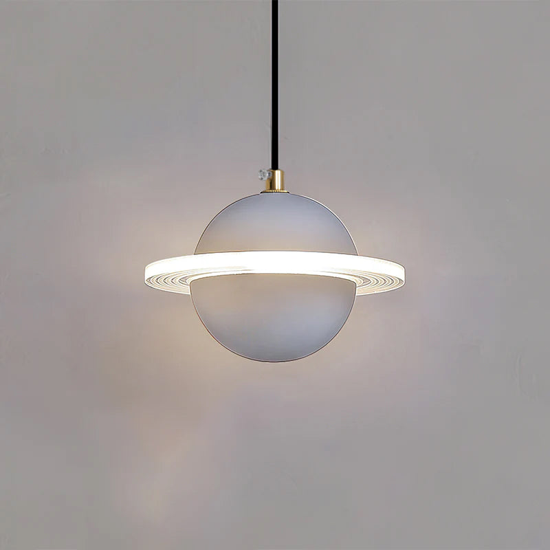 Smooth pale grey Clérachic pendant with a lit ridged ring and brass cord top, with a faint halo on the wall.