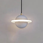 Smooth pale grey Clérachic pendant with a lit ridged ring and brass cord top, with a faint halo on the wall.