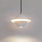 Pale speckled grey Clérachic pendant with a lit ring, and a bright pool of light on the wall below it.