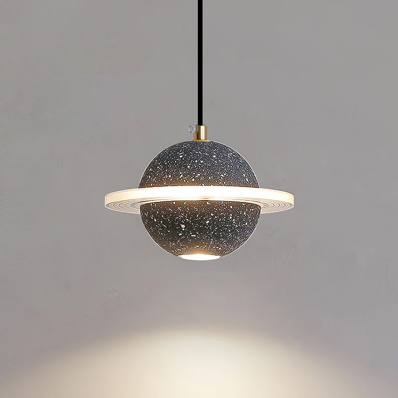 Lit sand black Clérachic pendant with a bright ring and a downlight, with a warm pool of light on the wall below.