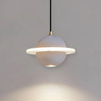 A smooth pale grey Clérachic pendant with a lit ridged ring and a downlight, with a pool of light on the grey wall beneath.