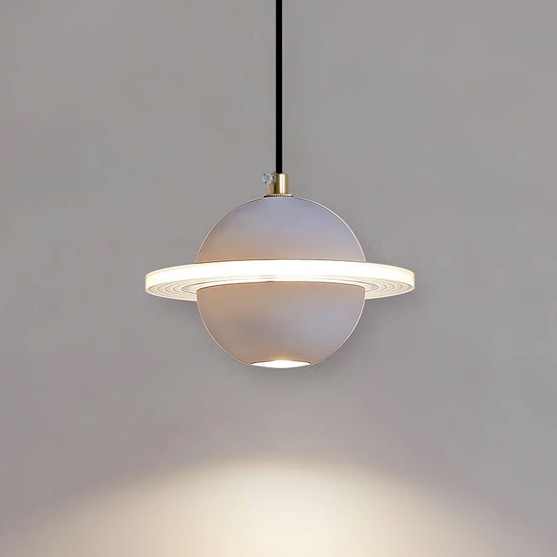 A smooth pale grey Clérachic pendant with a lit ridged ring and a downlight, with a pool of light on the grey wall beneath.