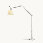 Clérachic arc floor lamp with a silver jointed arm and a cream fabric shade, on a round metal base against a plain backdrop.