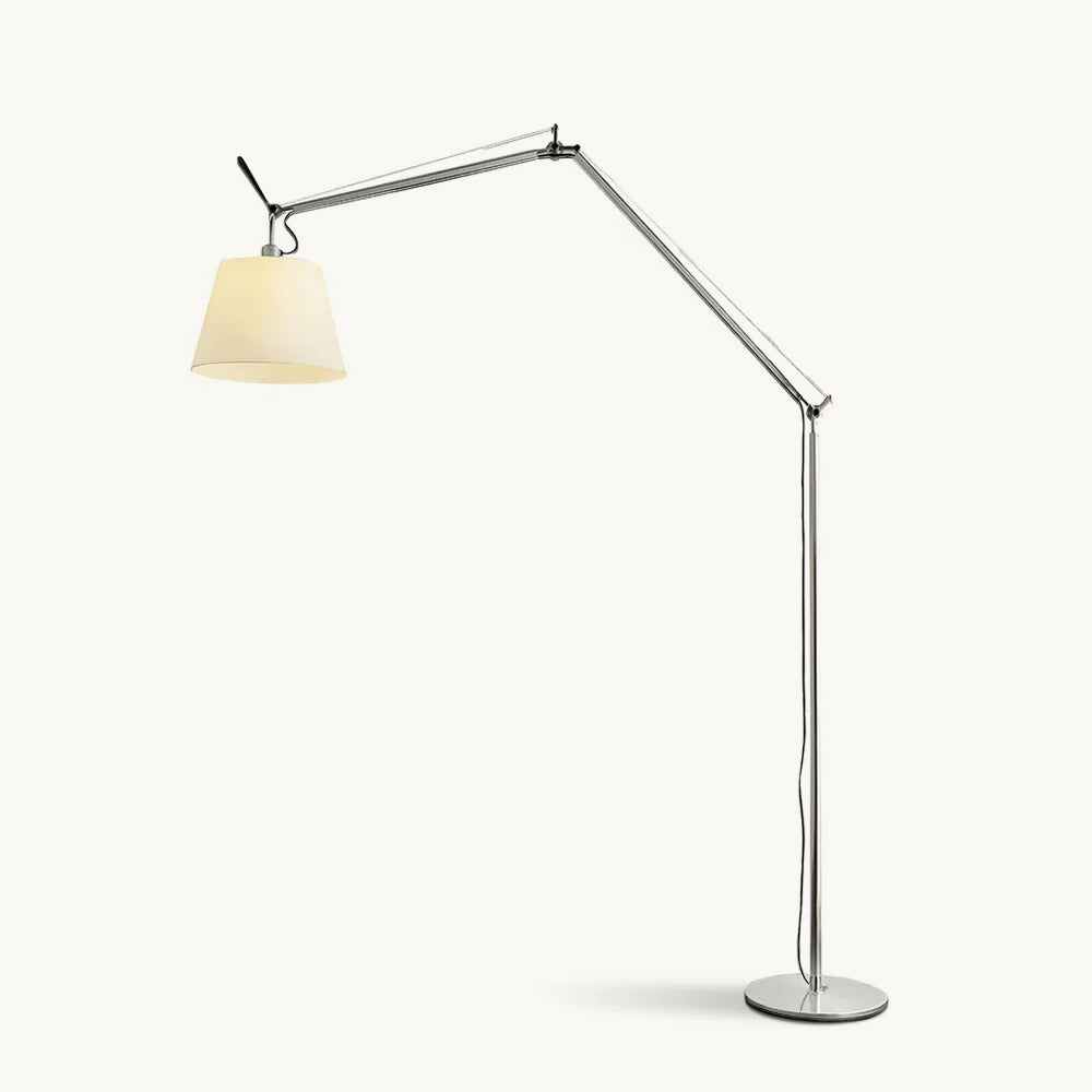 Clérachic arc floor lamp with a silver jointed arm and a cream fabric shade, on a round metal base against a plain backdrop.