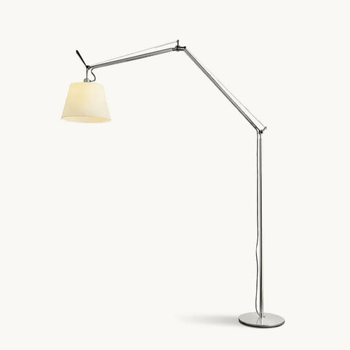 Clérachic arc floor lamp with a silver jointed arm and a cream fabric shade, on a round metal base against a plain backdrop.