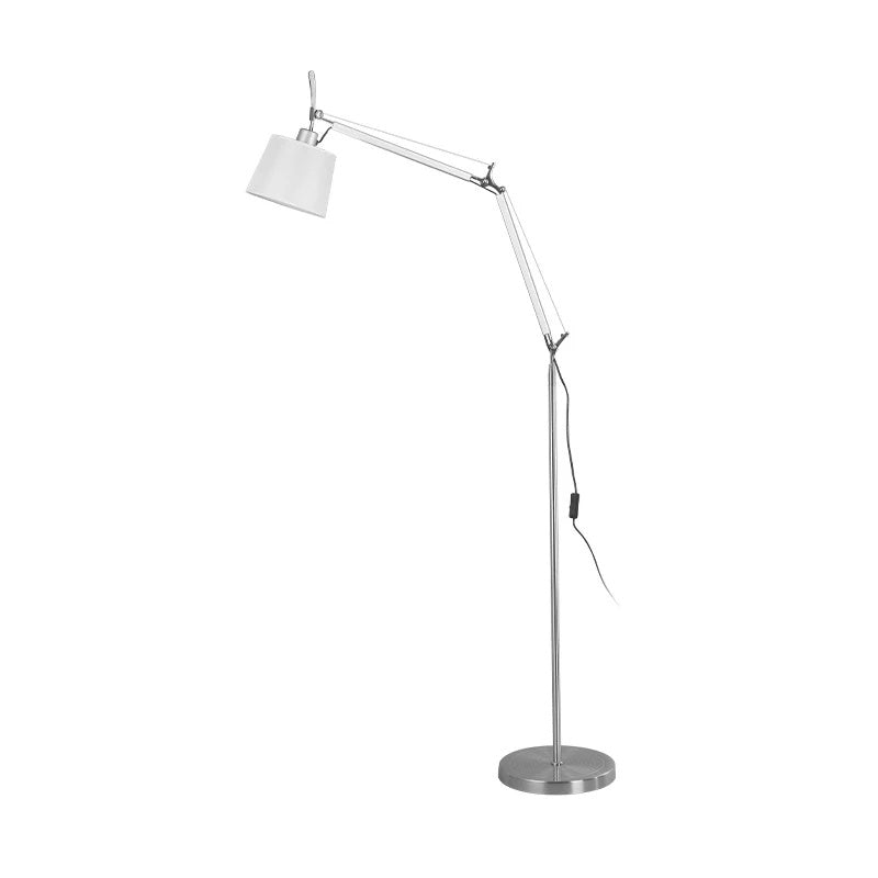 Clérachic floor lamp on a white backdrop with the shade angled left, a black cord along the pole and a round metal base.