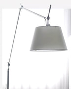 Close view of the grey fabric shade, silver arm joint and black adjusting handle on this Clérachic floor lamp.