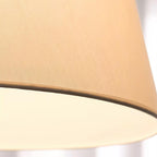Close view of the fine fabric weave on the lit shade of this Clérachic floor lamp.