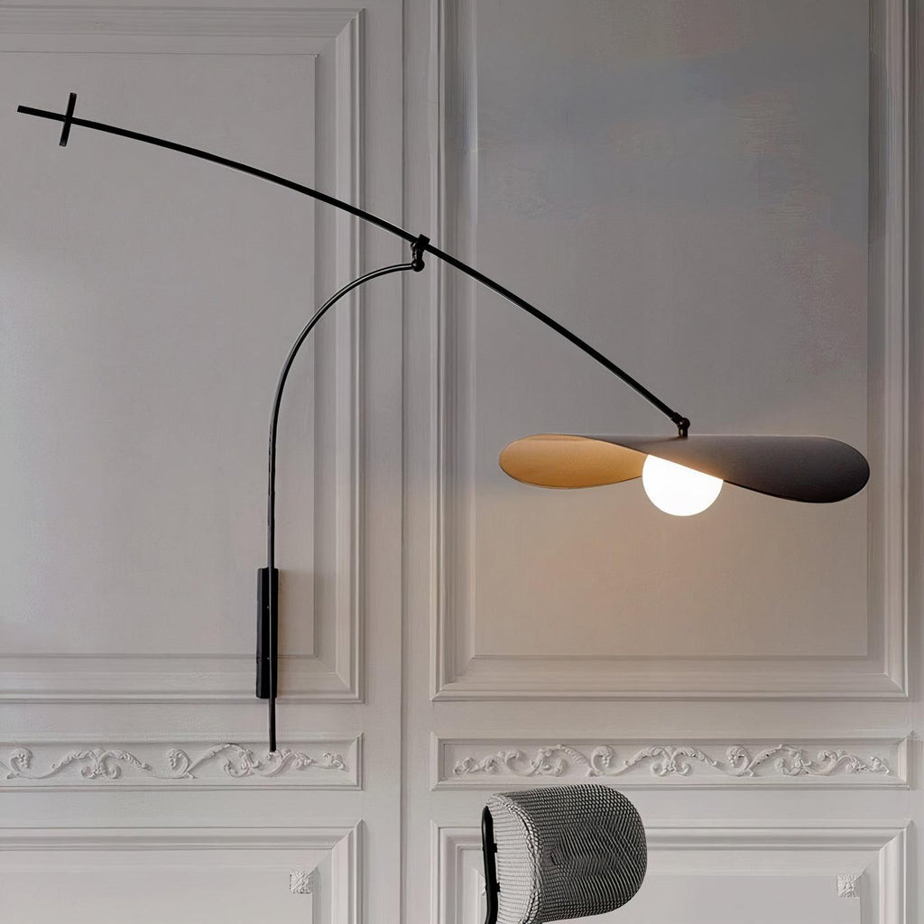 On a panelled white wall with plaster mouldings, this Clérachic wall light lights its gold-lined black shade.