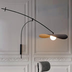 On a panelled white wall with plaster mouldings, this Clérachic wall light lights its gold-lined black shade.